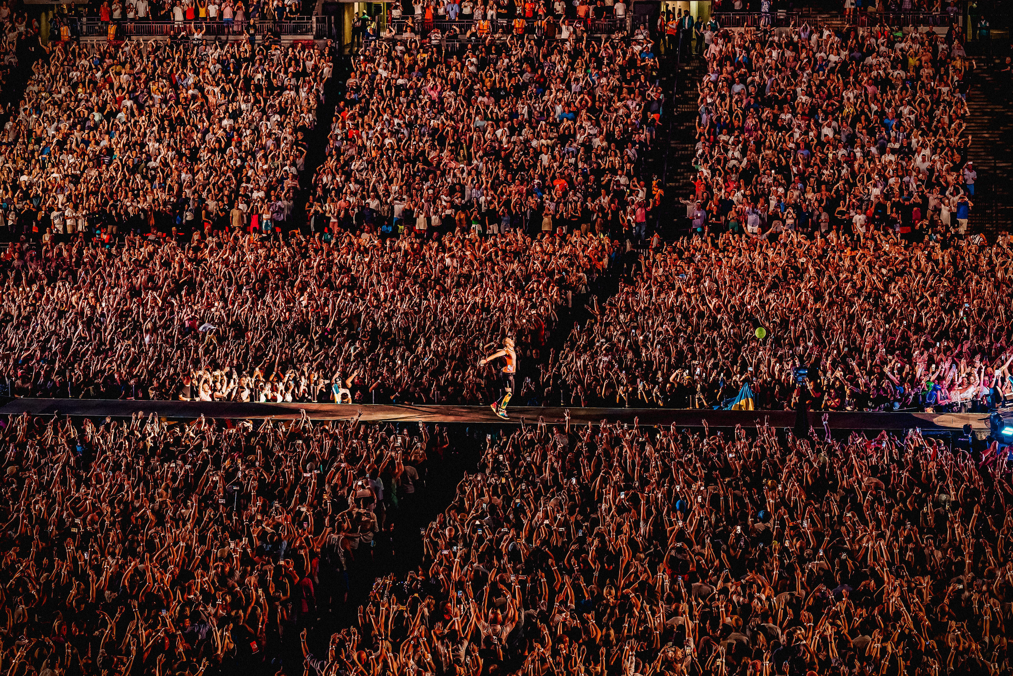 Chris Martin of Coldplay gliding down the runway at one of the group's sold out Wembley Stadium shows. Taken by Luke Dyson. This image won at the Event Photography Awards 2023